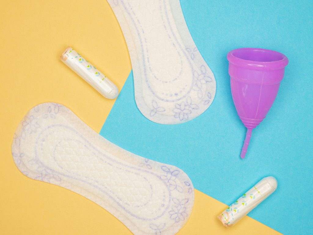 Menstrual products arranged against a colorful background
