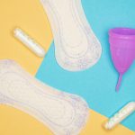 Menstrual products arranged against a colorful background