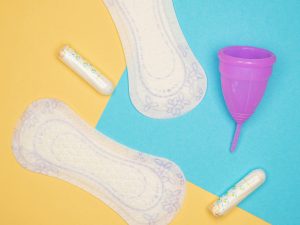 Menstrual products arranged against a colorful background