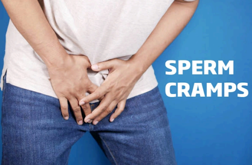 Photo of man wincing in pain and holding his crotch.